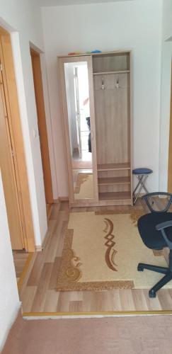 a hallway with a shower and a chair and a rug at Daily rental apartment Travnik in Travnik