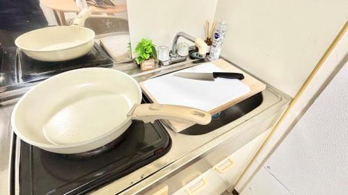 a kitchen counter with a bowl on a stove at Good One Awaji Accessia 401 in Osaka
