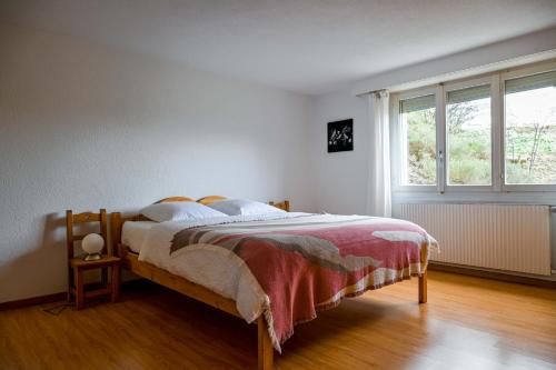 a bedroom with a bed and a window at Le Cerisier in Erde