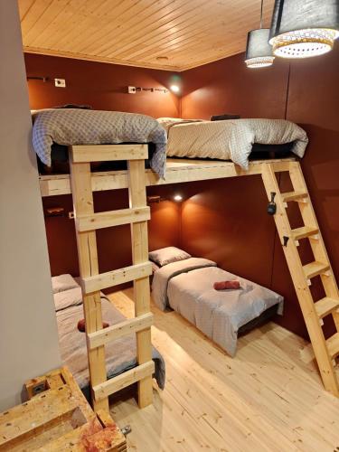 a room with two bunk beds and a bed at Kihlangin Koulu Guest House in Muonio