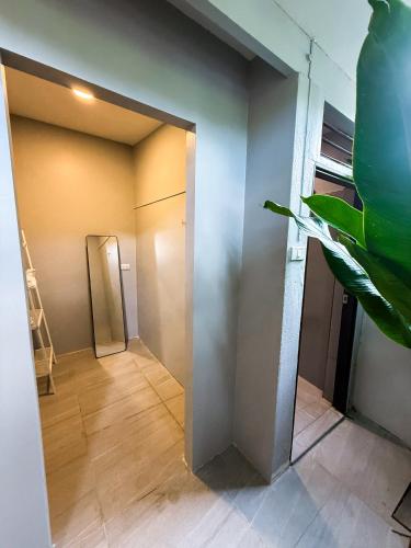 a hallway with a door leading to a room at Pridi cozy home with good location Type A in Bangkok