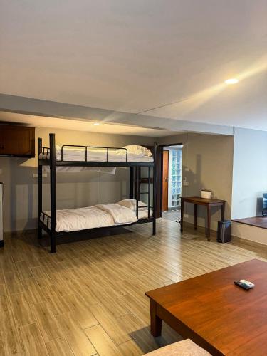 a living room with two bunk beds and a table at Pridi cozy home with good location Type A in Bangkok