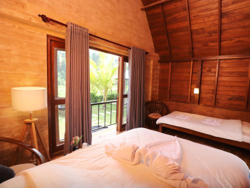 Postel nebo postele na pokoji v ubytování Maggona Boutique Cottages