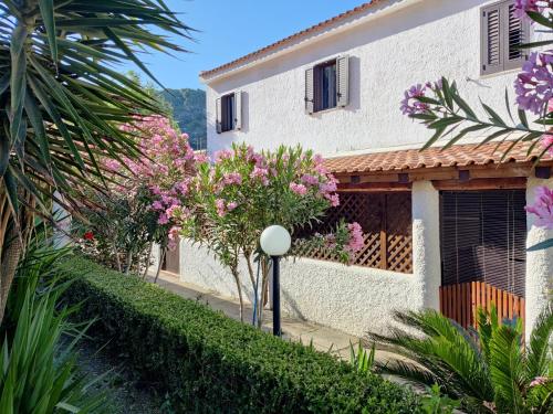 a house with pink flowers in front of it at Cottage84Milazzo in Milazzo