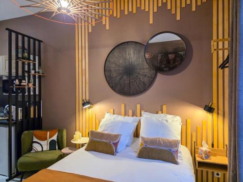 Ένα ή περισσότερα κρεβάτια σε δωμάτιο στο Les Appartements de la Nef d'Or