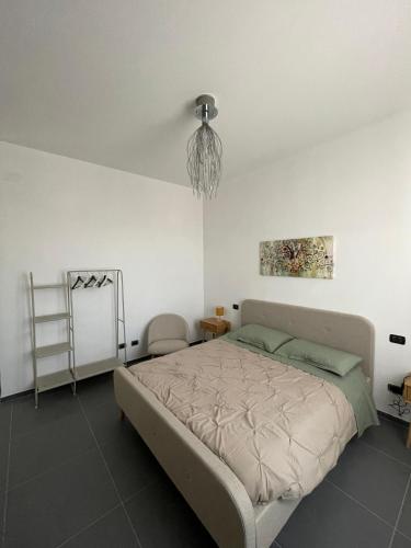 a bedroom with a bed and a chandelier at Casa Campanella in Spoleto