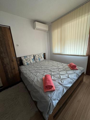 a bedroom with a bed with two towels on it at Guest House Tanevi in Devin