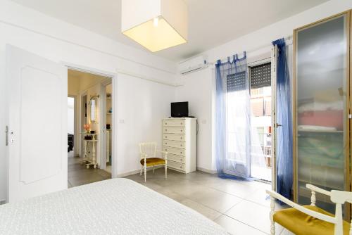 a white bedroom with a bed and a window at Casa Vacanze Nonna Elena in Rome