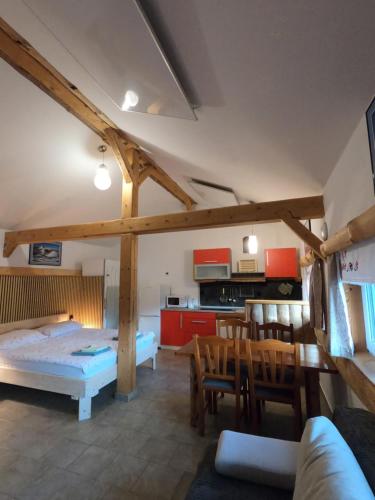a living room with a bed and a kitchen at Apartments Čebelica in Bohinj