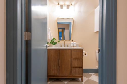 a bathroom with a sink and a mirror at The Francesca - Apt 334 in Bryan