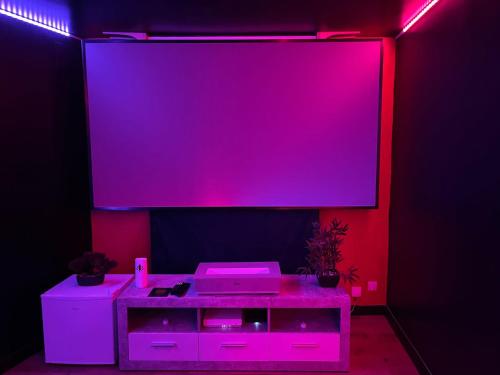 a stage with a pink screen and a purple wall at CY L'unique instant in Wingles