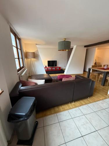a living room with a couch and a table at Charme cœur Obernai idéal marché de Noel in Obernai
