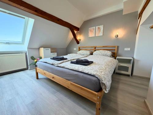 a bedroom with a large bed and a large window at Gasthaus Bomsdorf - ruhige Lage, free WLAN & Parken, Self Check-In, Smart-TV in Bomsdorf