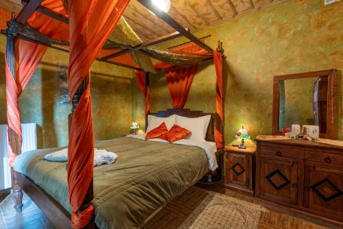 a bedroom with a canopy bed in a room at Ξενώνας Οντάς & Spa in Arachova