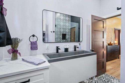 a bathroom with a sink and a mirror at Historic French Royal Estate at Capitol, Downtown! in Austin