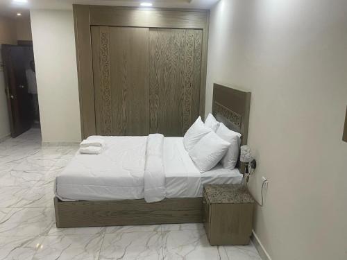 a bedroom with a bed with white sheets and pillows at vision suites Arbia Hurghada in Hurghada