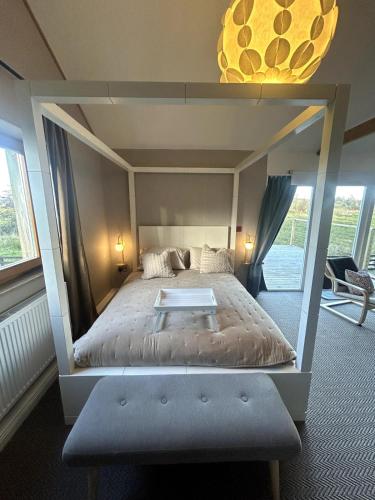 a bedroom with a bed with a large bed frame at Waterside Cabin in Belturbet