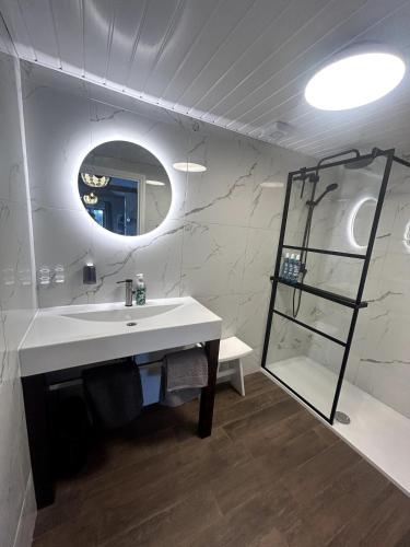 a bathroom with a sink and a mirror at Waterside Cabin in Belturbet