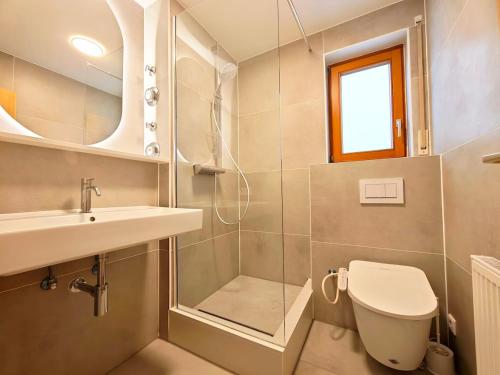 a bathroom with a toilet and a sink and a shower at Your home with iconic TV tower views in Stuttgart
