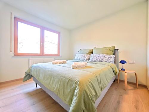 a bedroom with a bed with two towels on it at Your home with iconic TV tower views in Stuttgart