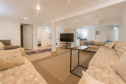 a living room with a couch and a television at Poolside Hideaway Heated Pool All Year Ideal for Groups Sleeps 6 plus in Victoria