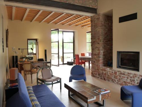 a living room with a blue couch and a fireplace at Domaine la Pause in Aveyron in Vabres-lʼAbbaye