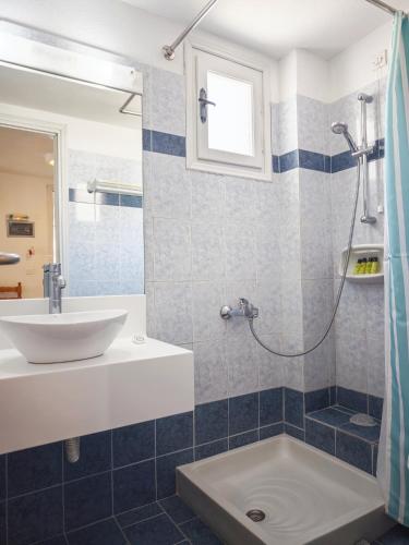 a bathroom with a sink and a shower at Aretousa Villas in Perissa