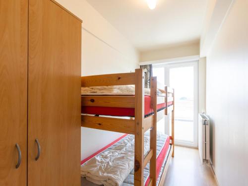 a room with two bunk beds and a closet at Con Amore - 0403 in Westende Bad