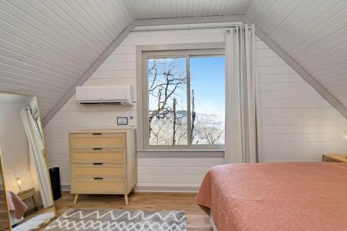 a bedroom with a bed and a large window at Calling Me Home in Blowing Rock