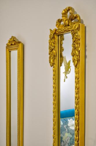 two mirrors on a wall next to each other at Kozimo boutique katoikia in Patra
