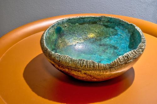 a bowl sitting on an orange plate at Kozimo boutique katoikia in Patra