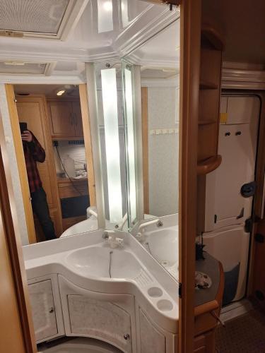 a bathroom with a sink and a mirror at Proboost Arctic Center Cosy Caravan in Rovaniemi
