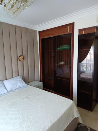 a bedroom with a white bed and a window at ParadiseHotel in Banī Ghālib