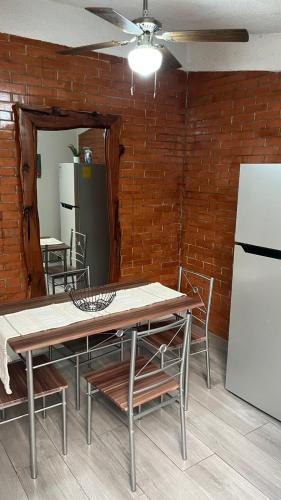 a dining room with a table and a refrigerator at Loft guelaguetza A in Santa Cruz Huatulco