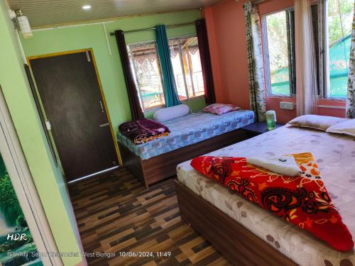 a bedroom with two beds and a mirror at Open view home stay in Mangpu