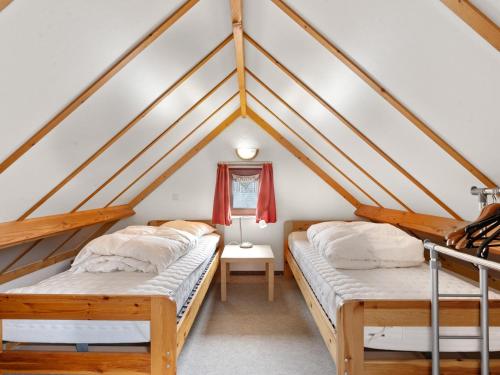 two beds in a room with a roof at Zeepark Haerendycke - Vakantiewoning 40 in De Haan