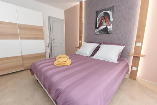 a bedroom with a bed with a yellow suitcase on it at Le Ray's Inn in Épernay