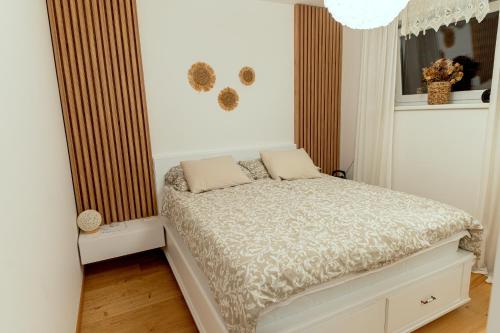 a small bedroom with a bed in a room at Anur Apartment II in Ptuj