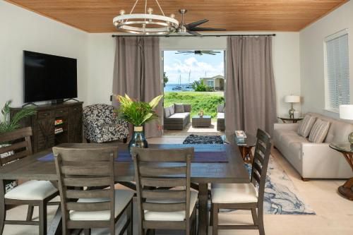 a dining room and living room with a table and chairs at Pirates Villa- Beach view with kayaks for Groups in Cruz Bay