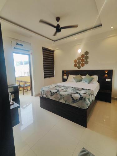 a bedroom with a bed and a ceiling fan at Suites19 in Bengaluru