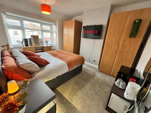 a bedroom with a bed with a netflix sign on the wall at Lovely 1-Bed City Centre escape with Kitchen & Free Parking in Spon End