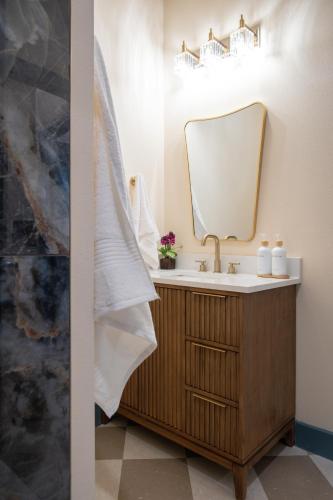 a bathroom with a sink and a mirror at The Francesca - Apt 332 in Bryan