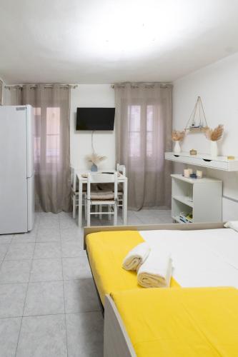 a living room with two beds and a refrigerator at Casa Gioia in Chioggia