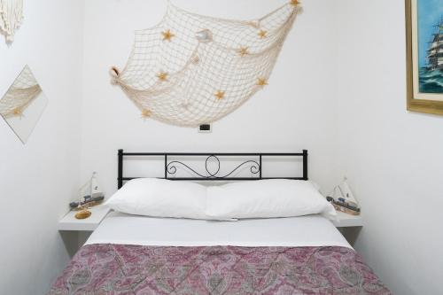 a bedroom with a bed and a hanging hammock at Casa Gioia in Chioggia