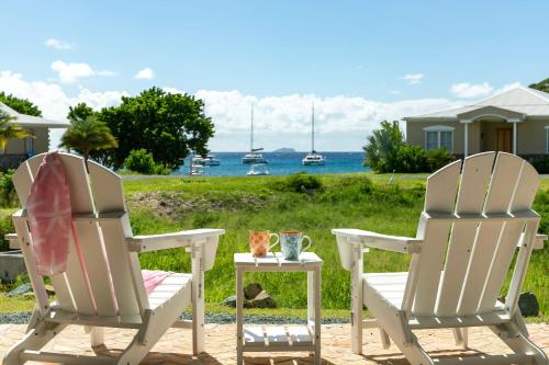two chairs and a table with a cup on it at Southern Star Villa Kayaks SUPS Steps to Beach in Monte