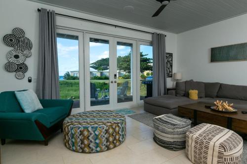 a living room with a couch and a table at Southern Star Villa Kayaks SUPS Steps to Beach in Monte