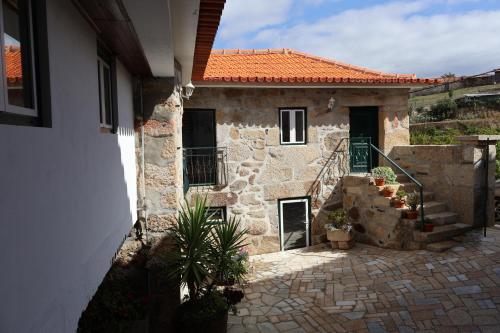 an outside view of a stone house with a staircase at Quinta da Lage Agroturismo e Enoturismo in Celorico de Basto