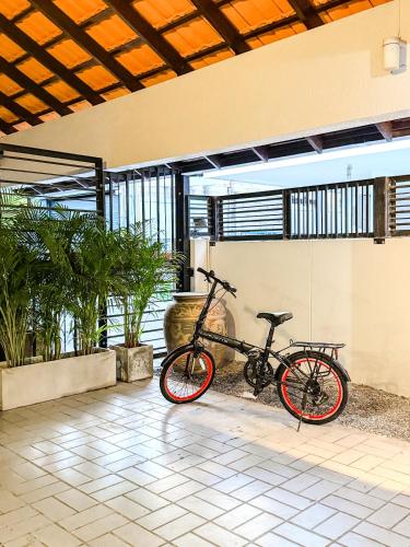 a bike is parked in a room with plants at Pridi cozy home with good location Type A in Bangkok