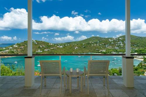 a table and chairs with a view of the ocean at Maria Breeze Villa - Stunning Ocean & Sunset Views Private Pool Spacious Rooms in Contant