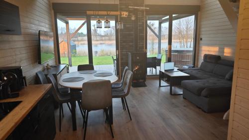 a living room with a table and a couch at Kozacki Domek in Lubowiec